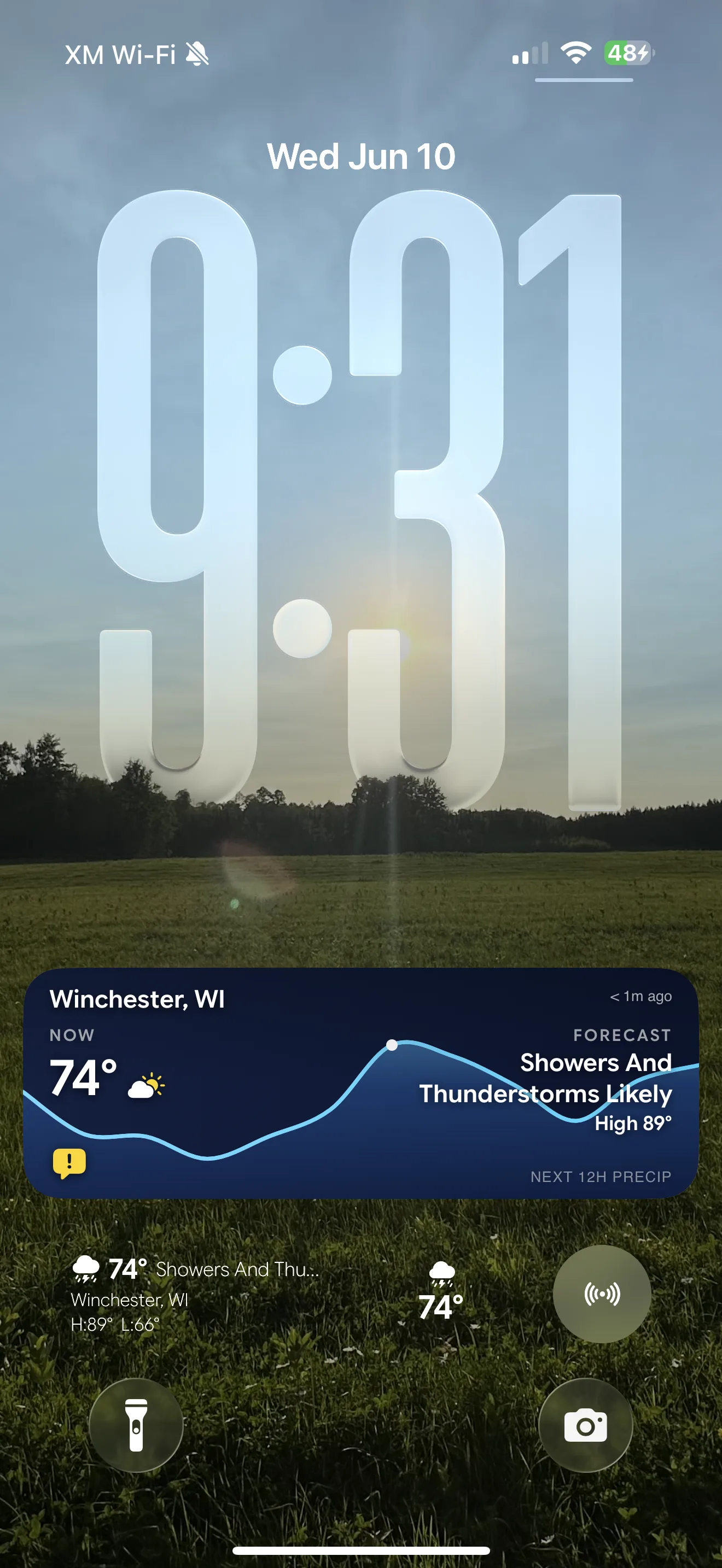 MesoSky Live Activity pinned to the iPhone lock screen, showing current temperature, the 12-hour precip curve, the day's forecast, and active conditions while the app is closed